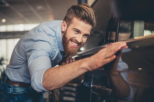 cool guy checking out a new car