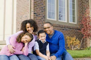 family in front of home