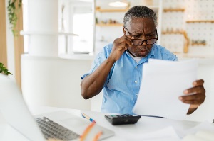 Elderly man looking at bills