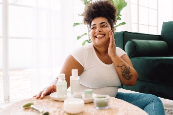 Woman sitting a table on floor smiling