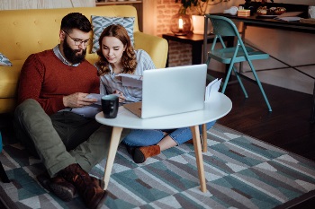 young couple reading financial to do list